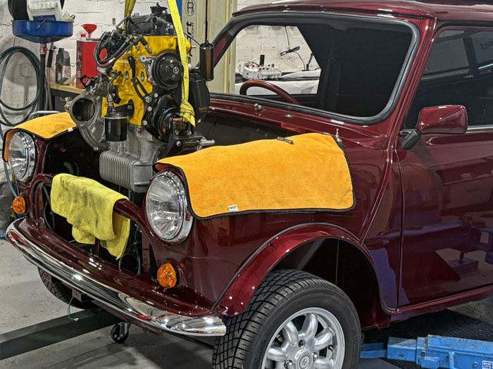 Reconditioned Mini engine being installed into the restored Mini 30