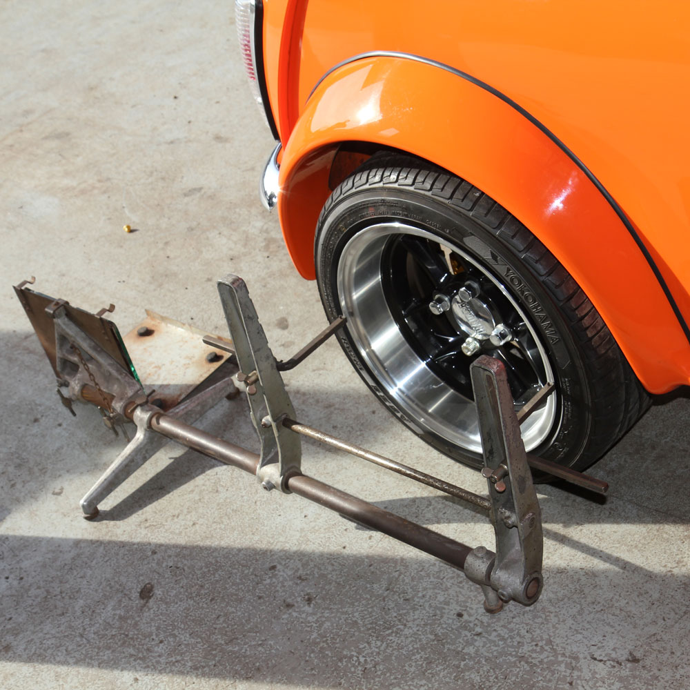 Technician checking Classic Mini ride height during suspension setup